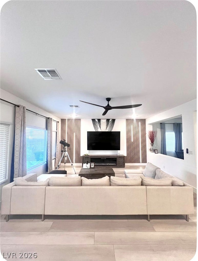 8683 S Black Cordon Road, Las Vegas, NV 89139 Gleaming floors and built-in wall accents enhance this open and welcoming living space.