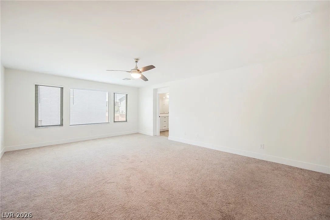 8683 S Black Cordon Road, Las Vegas, NV 89139 Plentiful natural light streams across this carpeted bedroom through generous windows.