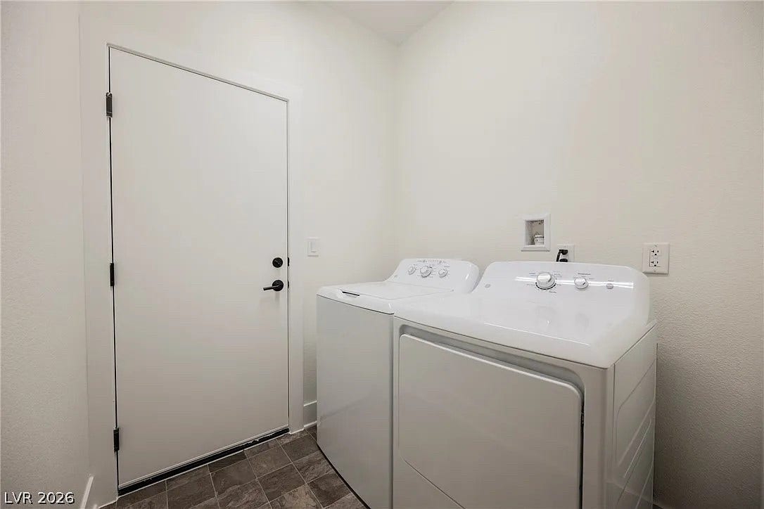 8683 S Black Cordon Road, Las Vegas, NV 89139 A dedicated laundry space features clean walls and durable tile flooring.