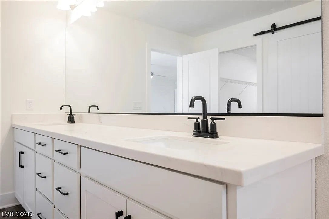 8683 S Black Cordon Road, Las Vegas, NV 89139 Clean lines and a spacious dual vanity define this modern bathroom space.