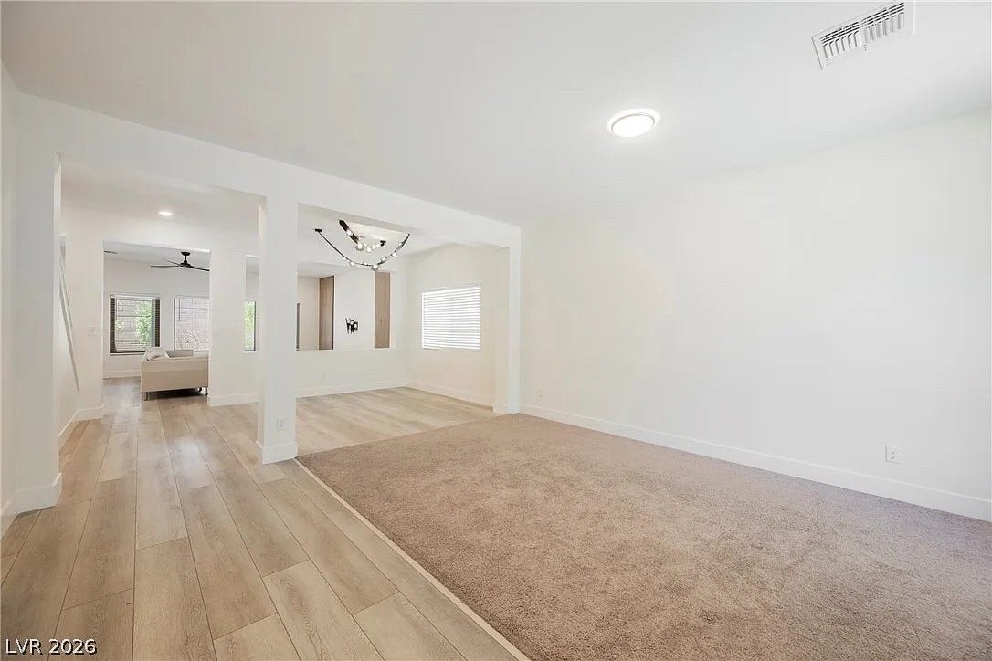 8683 S Black Cordon Road, Las Vegas, NV 89139 Clean lines and smooth flooring define this light-filled, versatile open living area.