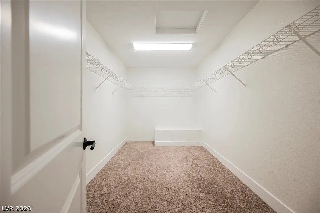 8683 S Black Cordon Road, Las Vegas, NV 89139 Ample wire shelving lines this clean walk-in closet featuring neutral carpeting.