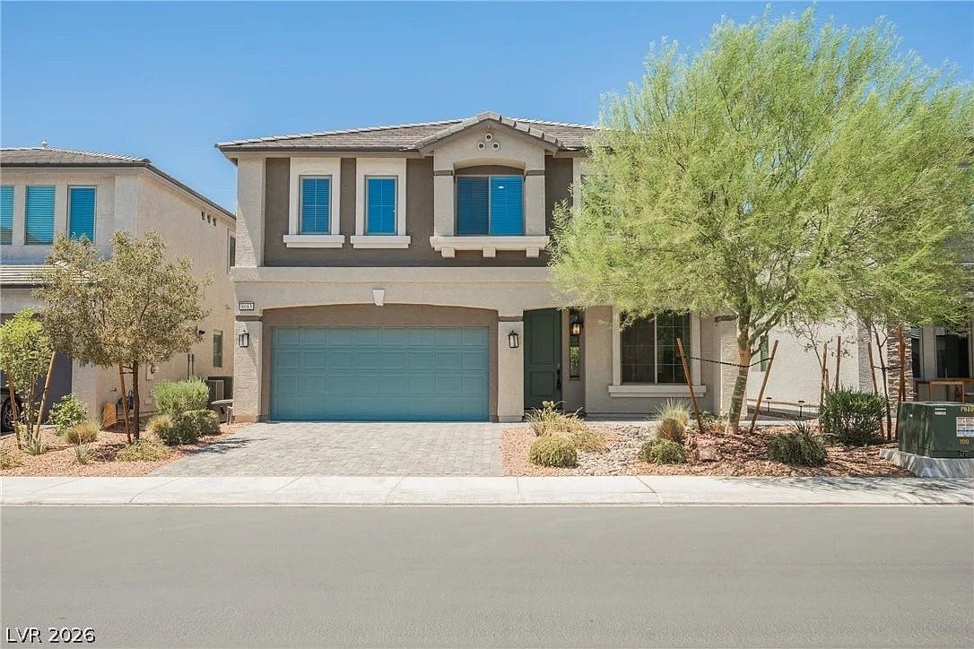 8683 S Black Cordon Road, Las Vegas, NV 89139 Clean lines and stone-paved driveway define this modern two-story home exterior.