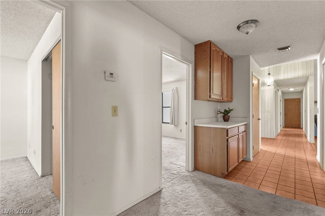 5601 Paseo Recallo Court, Las Vegas, NV 89108 An inviting hallway layout transitions smoothly from tiled walkways to carpeted living areas.