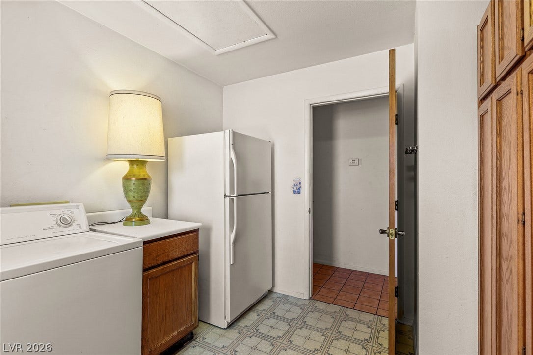 5601 Paseo Recallo Court, Las Vegas, NV 89108 Functional utility space features durable flooring and abundant wooden cabinetry.
