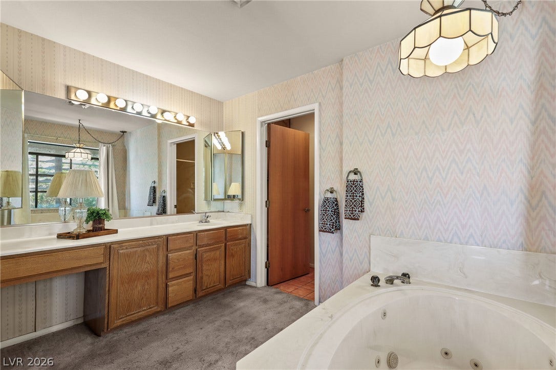 5601 Paseo Recallo Court, Las Vegas, NV 89108 An integrated wood vanity and soaking tub highlight this master bath layout.