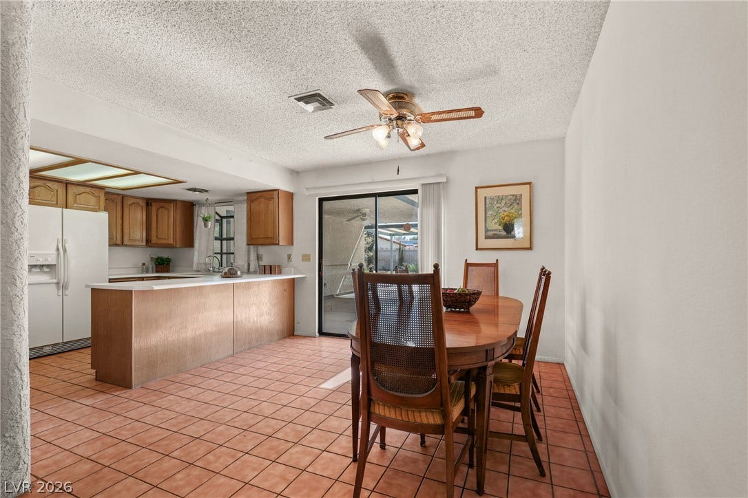 5601 Paseo Recallo Court, Las Vegas, NV 89108 Terracotta tile floors flow from the dining area directly into the open-concept kitchen.