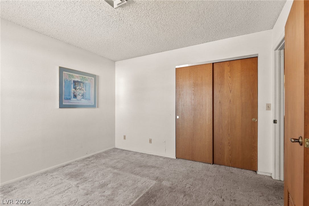 5601 Paseo Recallo Court, Las Vegas, NV 89108 Soft carpeting underfoot defines this comfortable room complete with a sliding closet door.