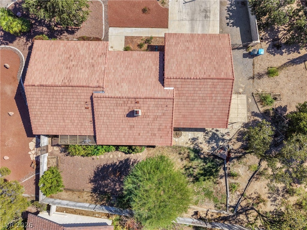 5601 Paseo Recallo Court, Las Vegas, NV 89108 A classic tile roof tops this home nestled within mature natural desert landscaping.