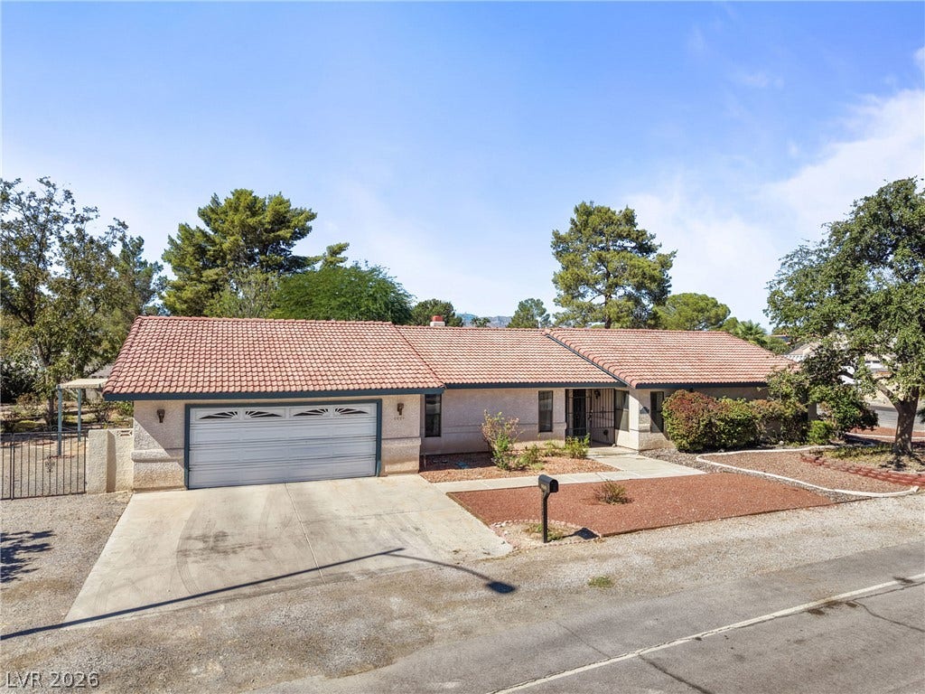 5601 Paseo Recallo Court, Las Vegas, NV 89108 A classic tile roof and spacious concrete driveway highlight this single-story ranch home.