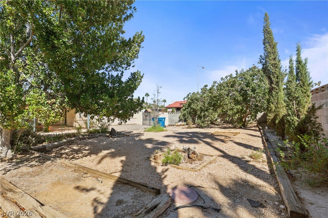 5601 Paseo Recallo Court, Las Vegas, NV 89108 Mature trees shade a spacious gravel yard bordered by sturdy block fencing.