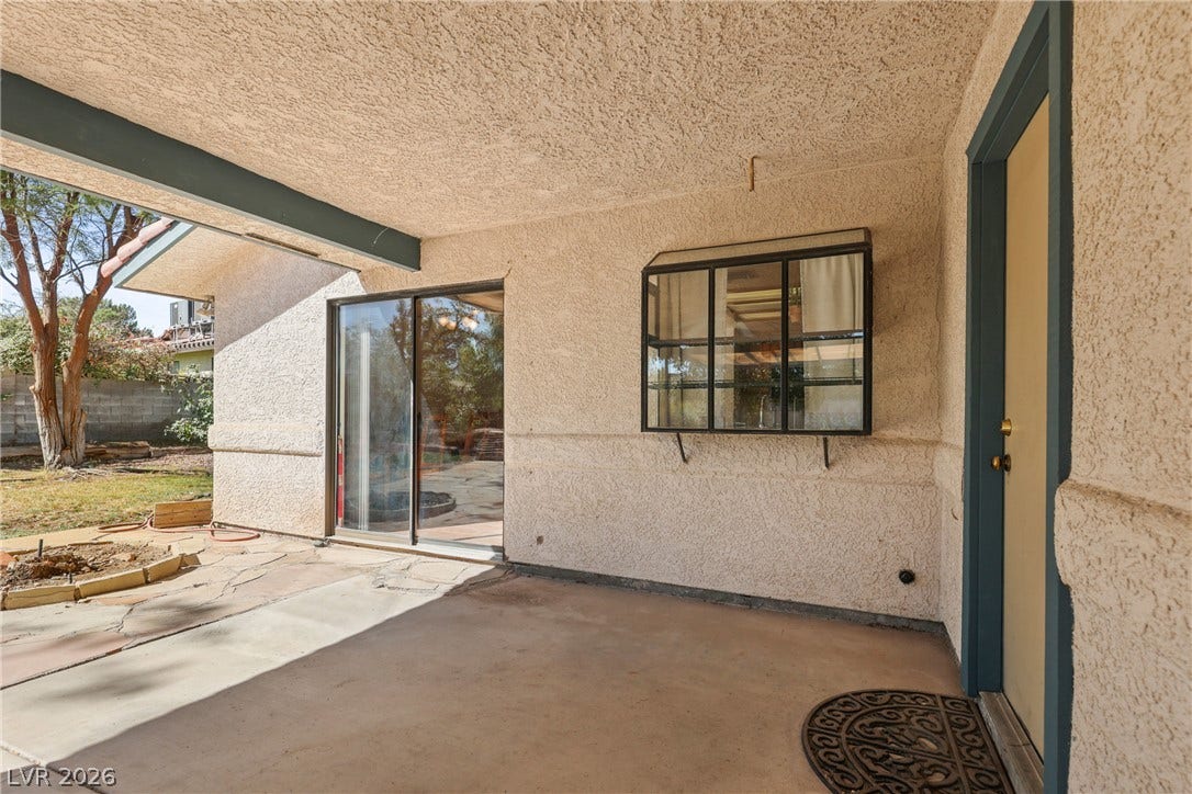 5601 Paseo Recallo Court, Las Vegas, NV 89108 An inviting covered patio offers textured stucco finishes and direct access to the back yard.
