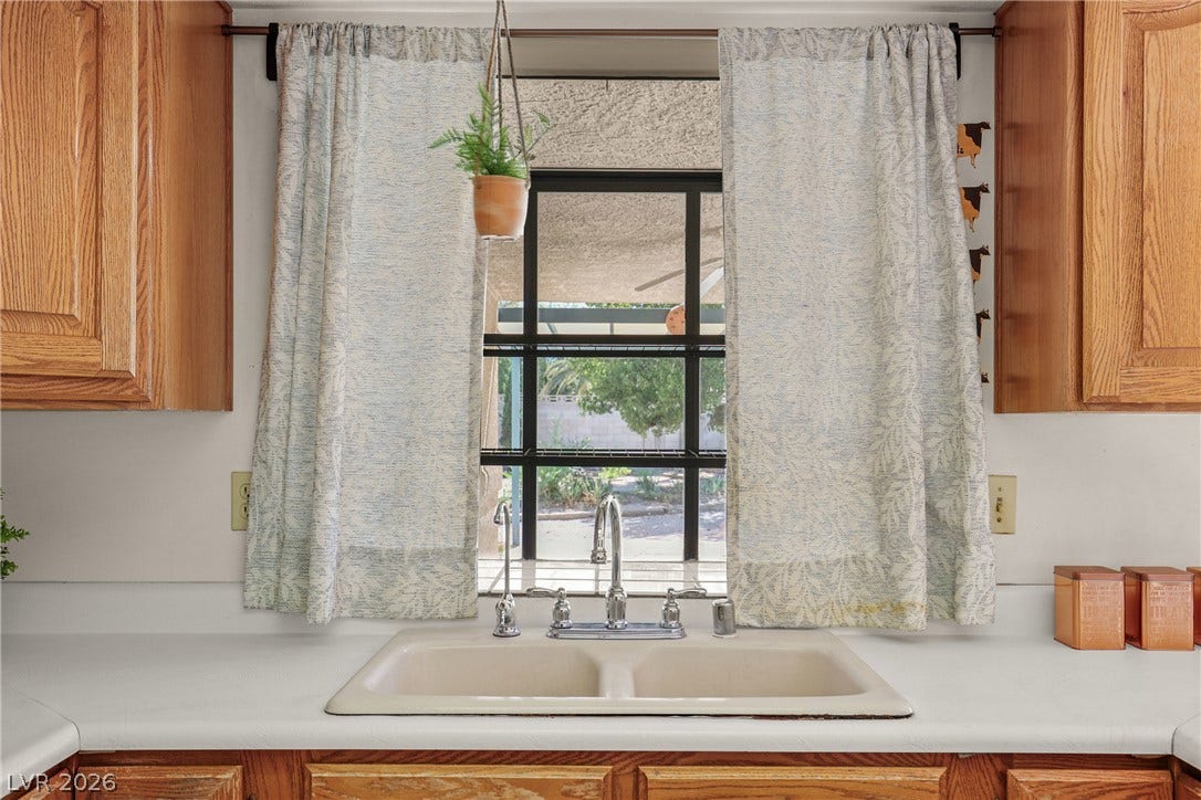 5601 Paseo Recallo Court, Las Vegas, NV 89108 Natural light streams over the double kitchen sink from a well-placed window.
