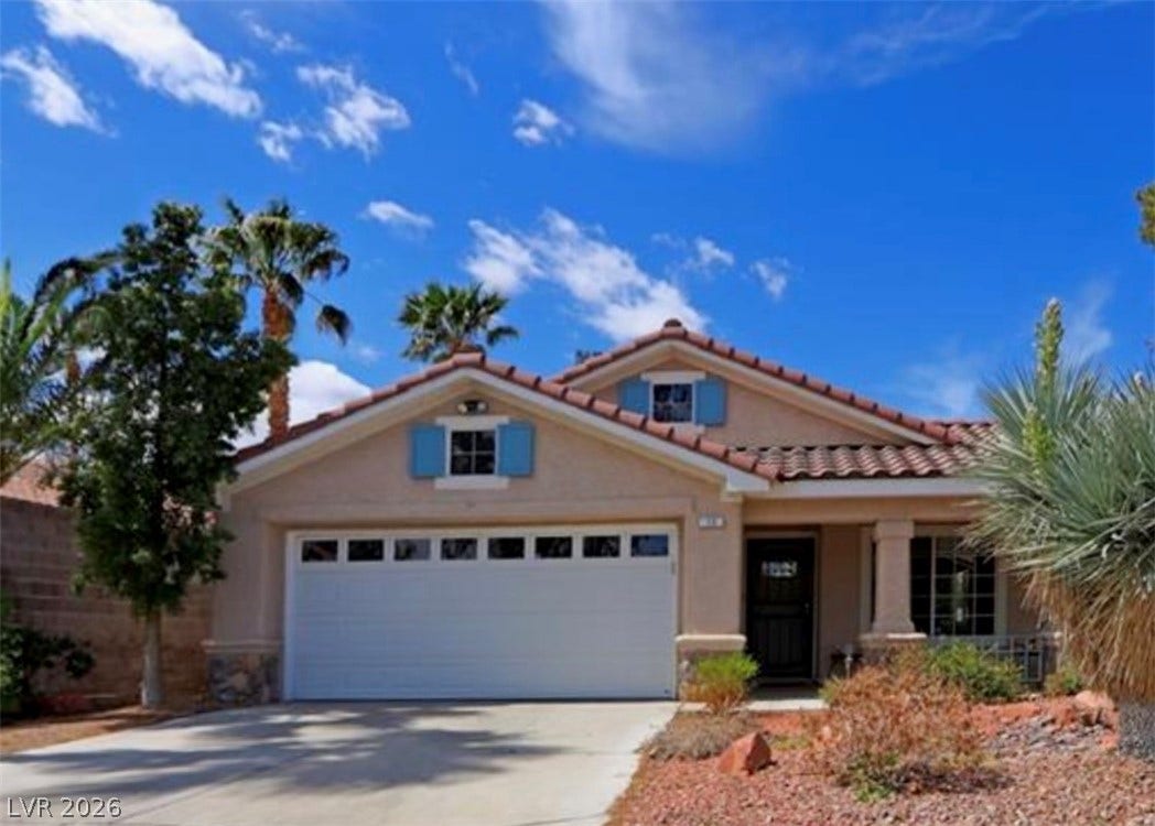 15 Rue des Champs, Henderson, NV 89074 Spanish tile roofing and classic stucco finishes define this desert-landscaped single-family residence.