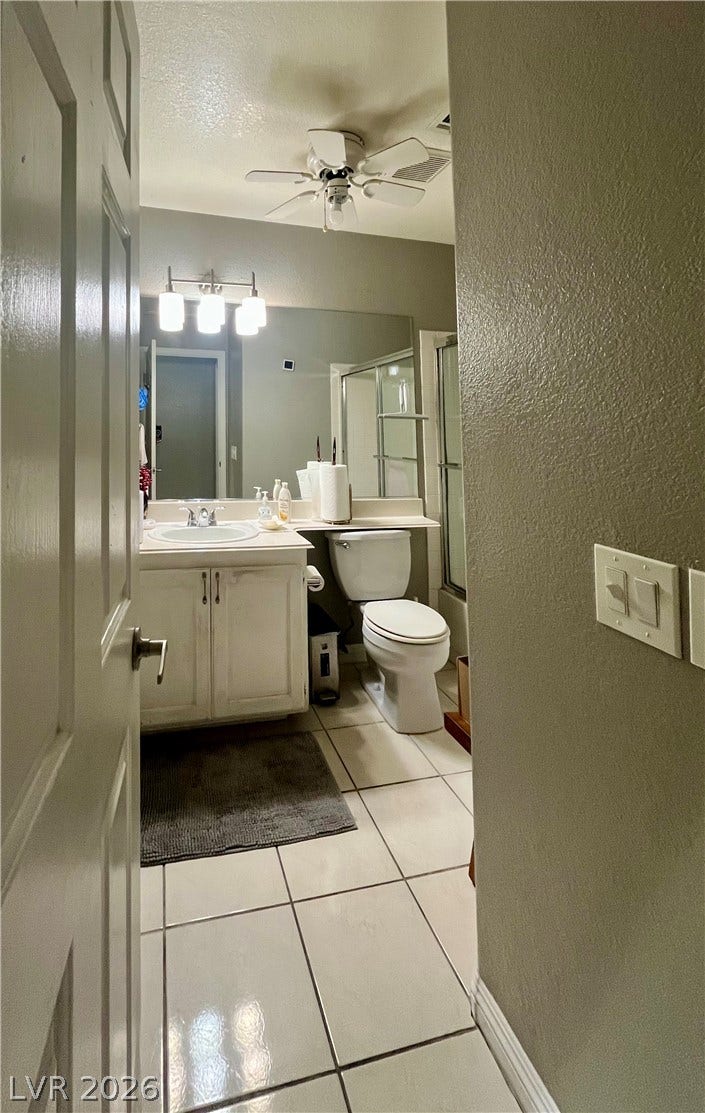 15 Rue des Champs, Henderson, NV 89074 Tiled flooring and a crisp white vanity define this functional full bathroom.