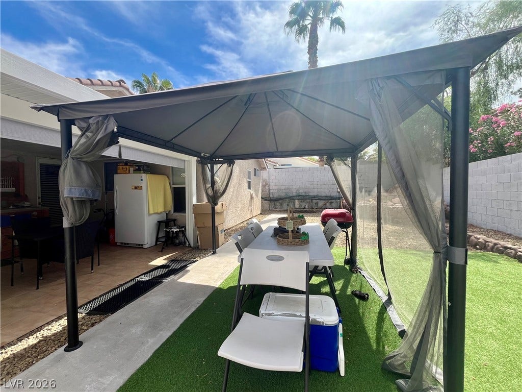 15 Rue des Champs, Henderson, NV 89074 An inviting outdoor pavilion setup overlooks a synthetic grass lawn and concrete walkways.