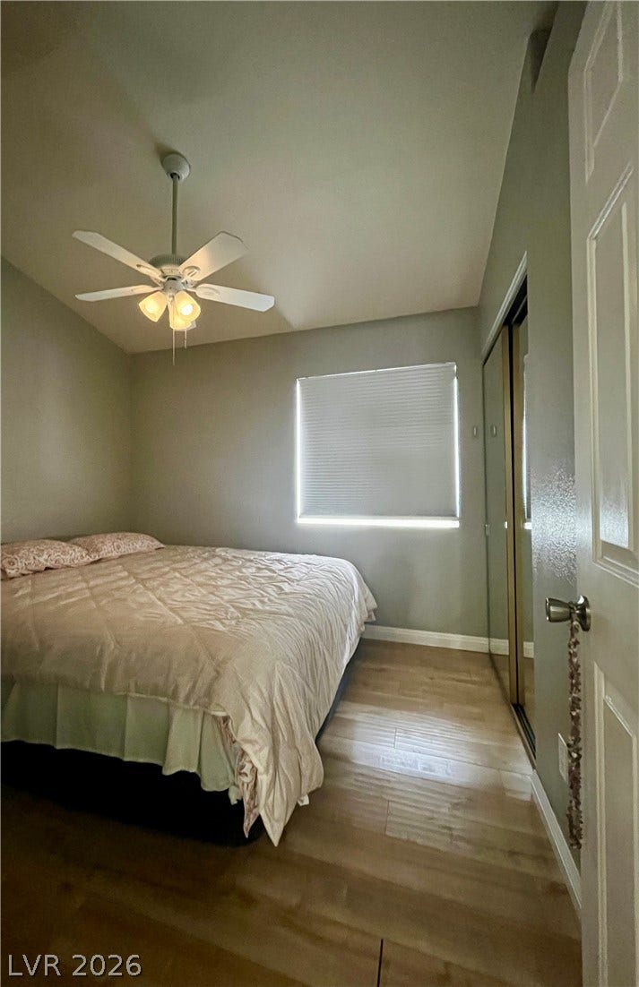 15 Rue des Champs, Henderson, NV 89074 Smooth wood-look flooring and a mirrored closet define this comfortable secondary bedroom.