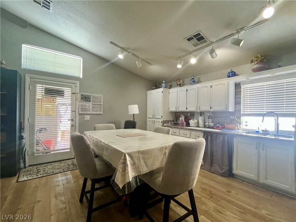 15 Rue des Champs, Henderson, NV 89074 Sloped ceilings and resilient wood-look flooring enhance this functional eat-in kitchen space.