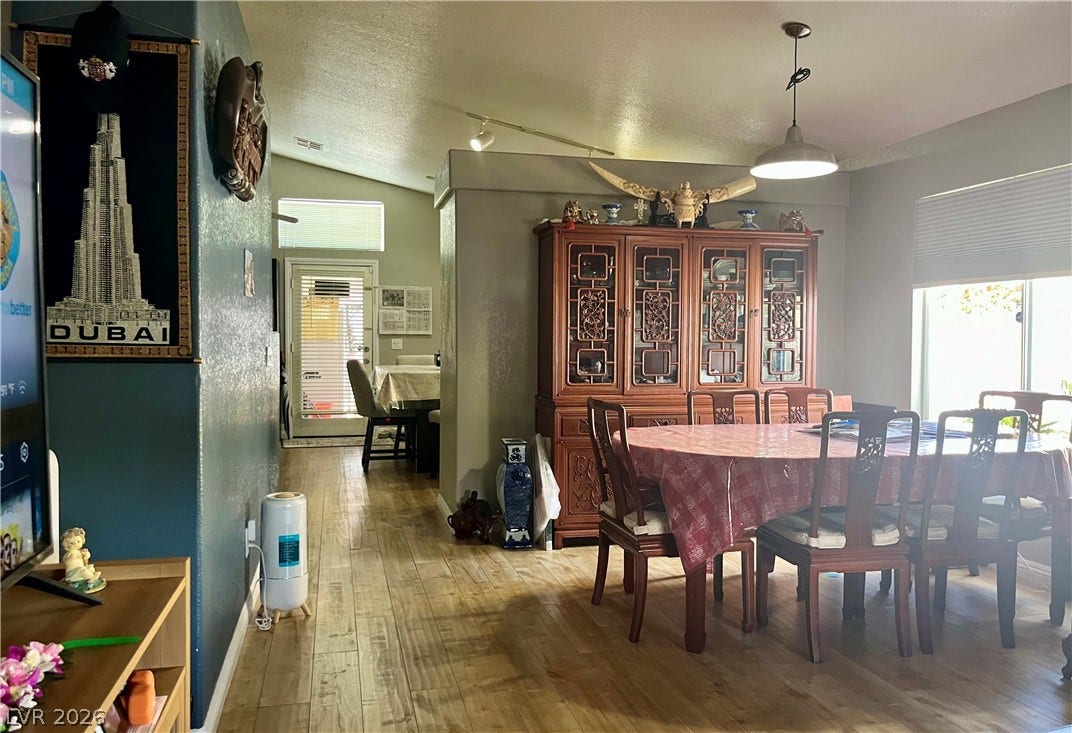 15 Rue des Champs, Henderson, NV 89074 Gleaming wood-look floors anchor this dining area under vaulted ceilings.