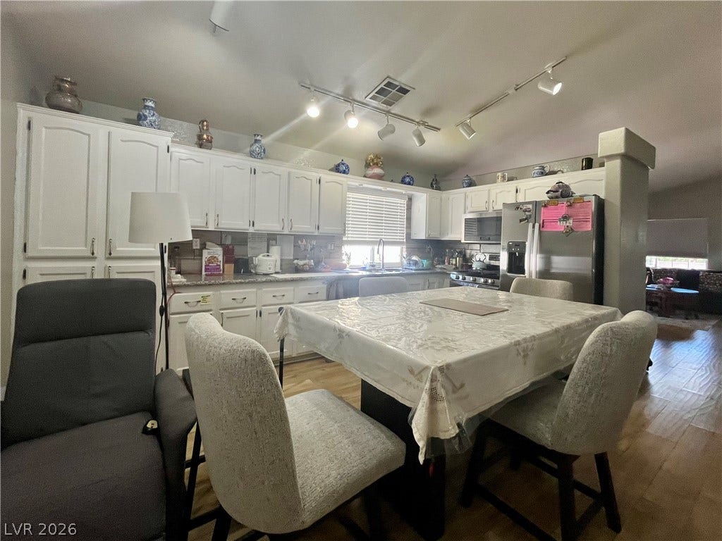 15 Rue des Champs, Henderson, NV 89074 Warm hardwood floors complement the spacious kitchen layout complete with classic cabinetry.