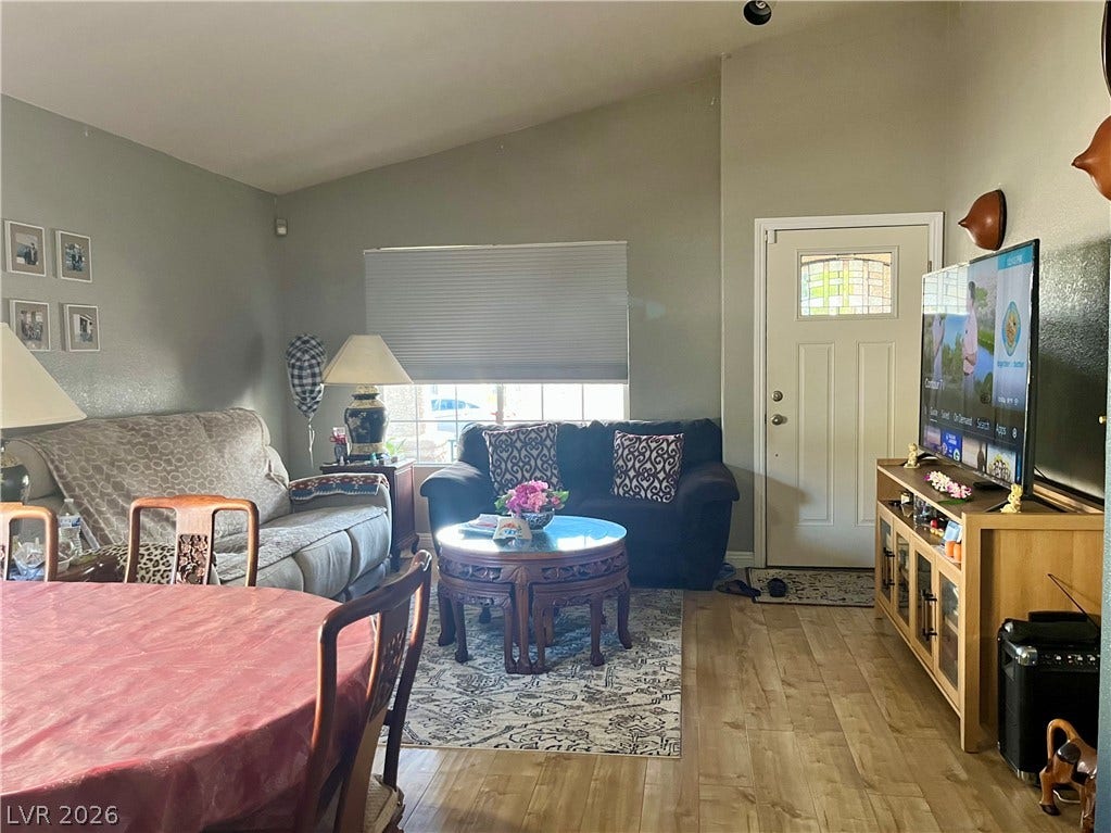 15 Rue des Champs, Henderson, NV 89074 Vaulted ceilings and warm wood floors anchor this comfortable open-concept living and dining area.
