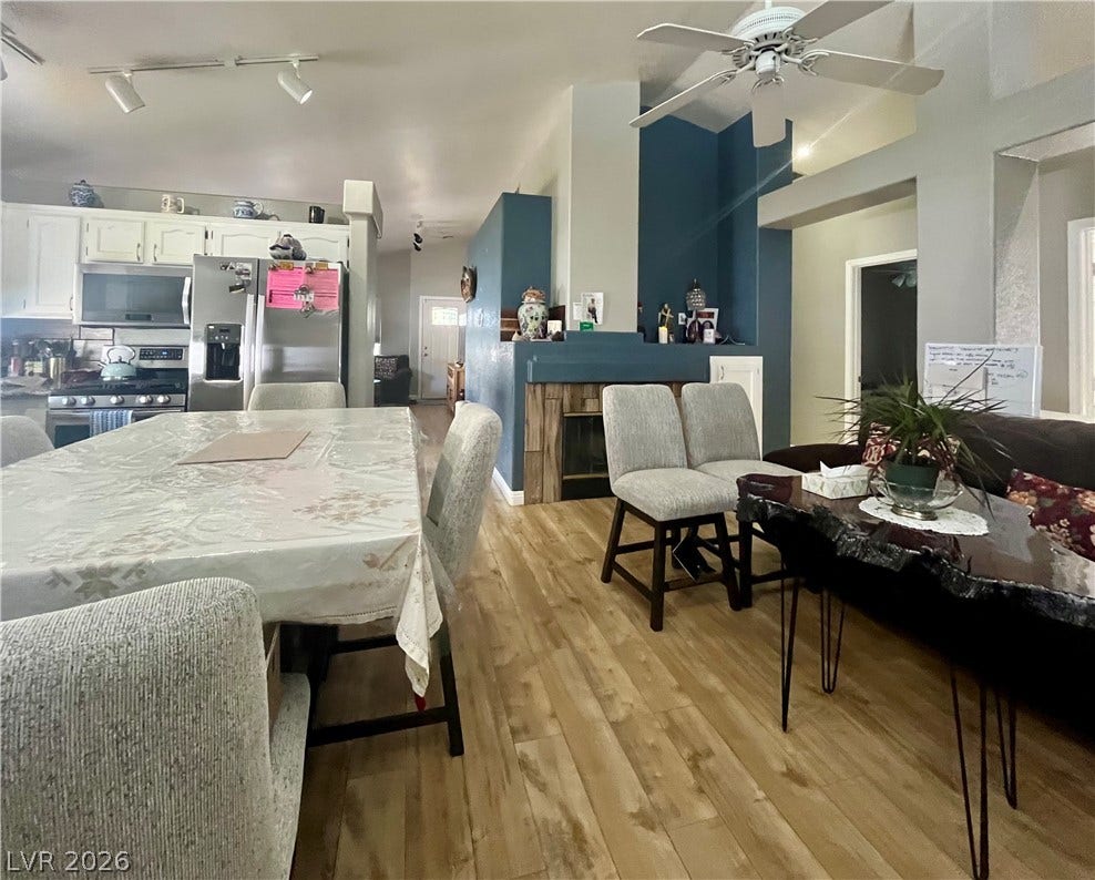 15 Rue des Champs, Henderson, NV 89074 An open-concept layout features durable wood-look flooring and a modern dual-sided fireplace hearth.