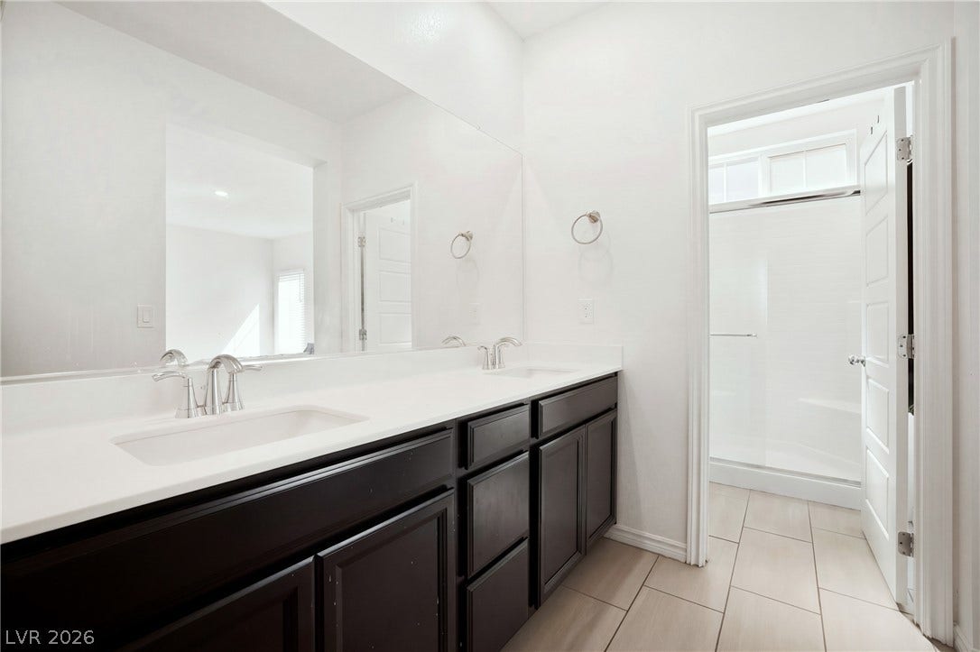 Clean lines and a spacious dual vanity define this modern bathroom layout.