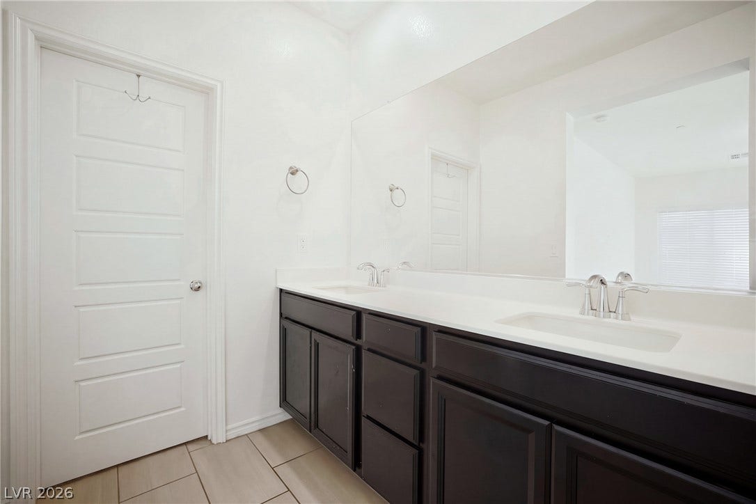 Clean lines and a spacious dual vanity define this modern bathroom space.