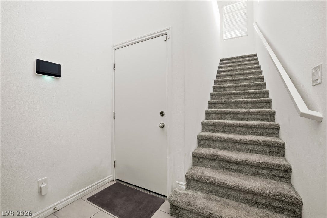 High ceilings and clean architectural lines define this welcoming entryway.