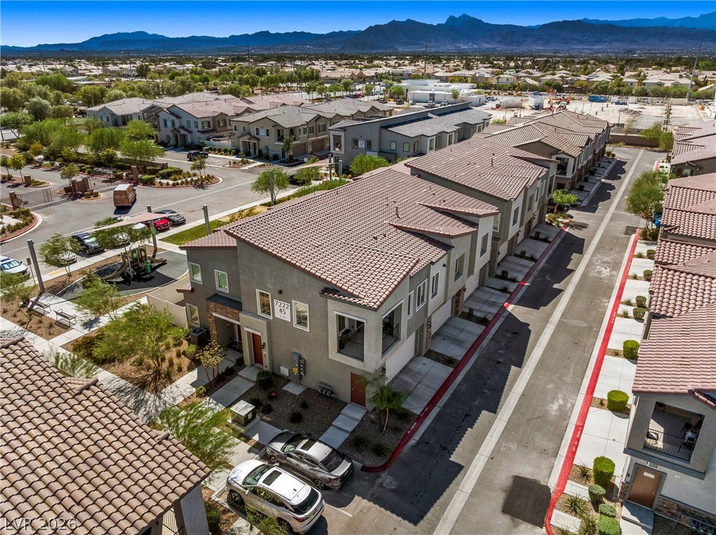 Dramatic mountain ranges rise beyond this contemporary multi-level residential development.