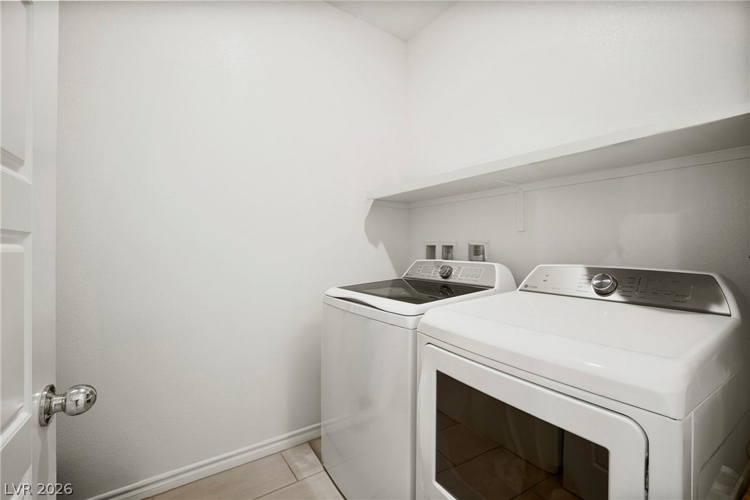 Functional tile flooring and built-in shelving maximize organization in this dedicated utility space.