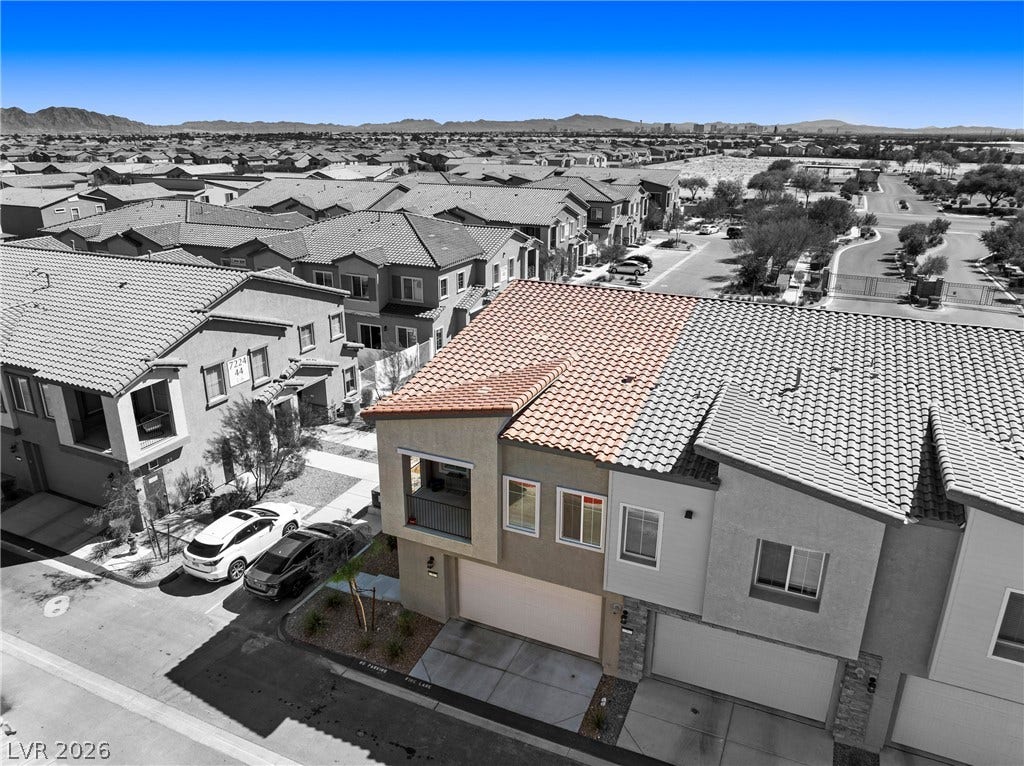 An aerial perspective captures the tiled roofs and neighborhood surroundings of this contemporary townhome.