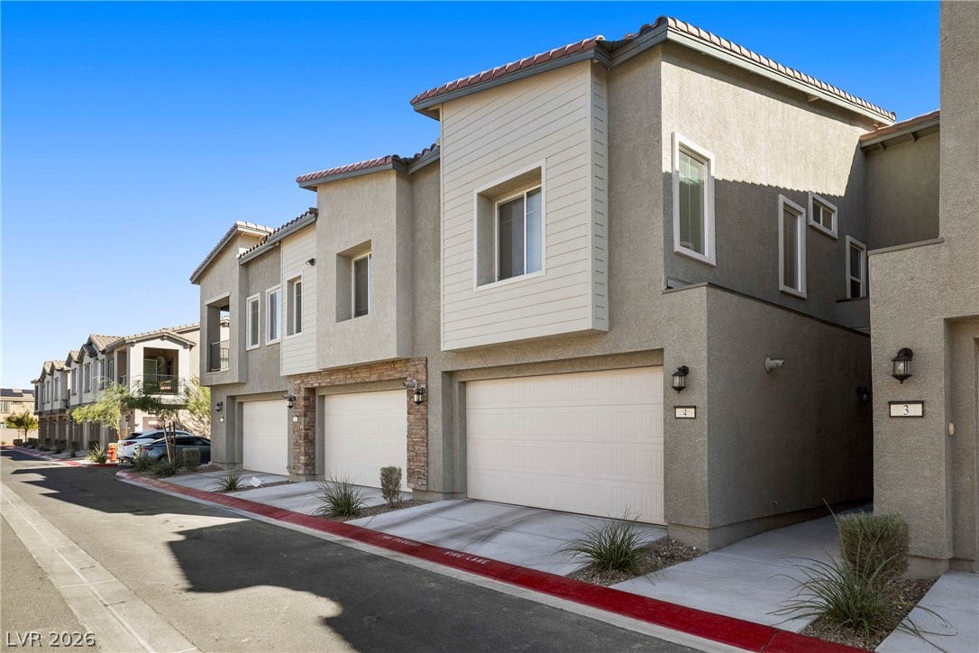 Modern multi-level exterior architecture showcases clean design lines and attached multi-car garages.