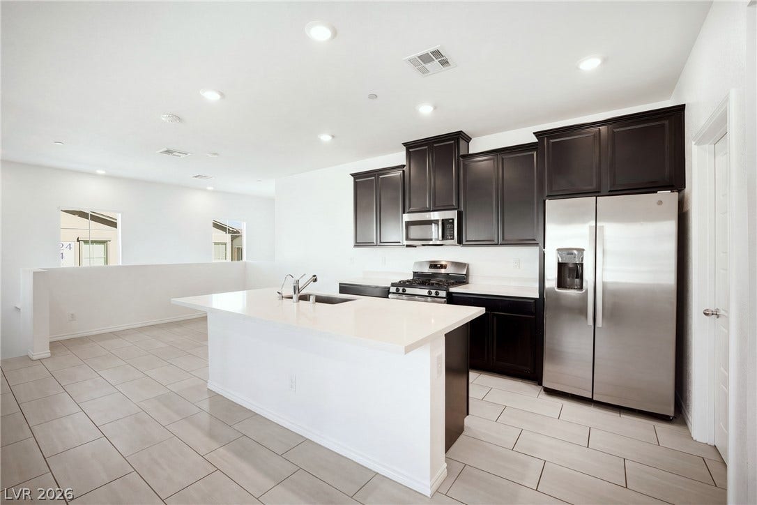 Sleek dark cabinetry and polished stone countertops elevate this contemporary culinary space.