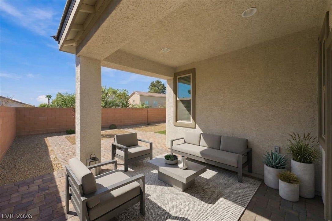 4209 Fairywren Drive, North Las Vegas, NV 89031 A covered patio with recessed lighting overlooking a private, walled yard.
