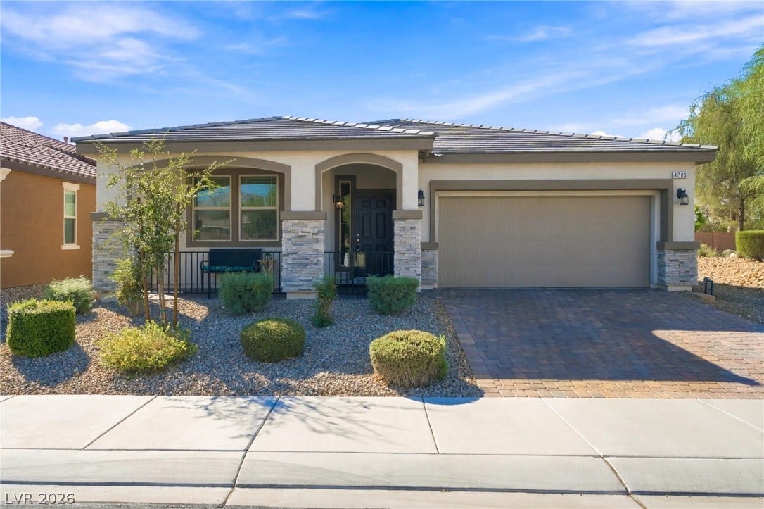 4209 Fairywren Drive, North Las Vegas, NV 89031 Stone accents and a tiled roof complement the classic stucco facade of this modern home.