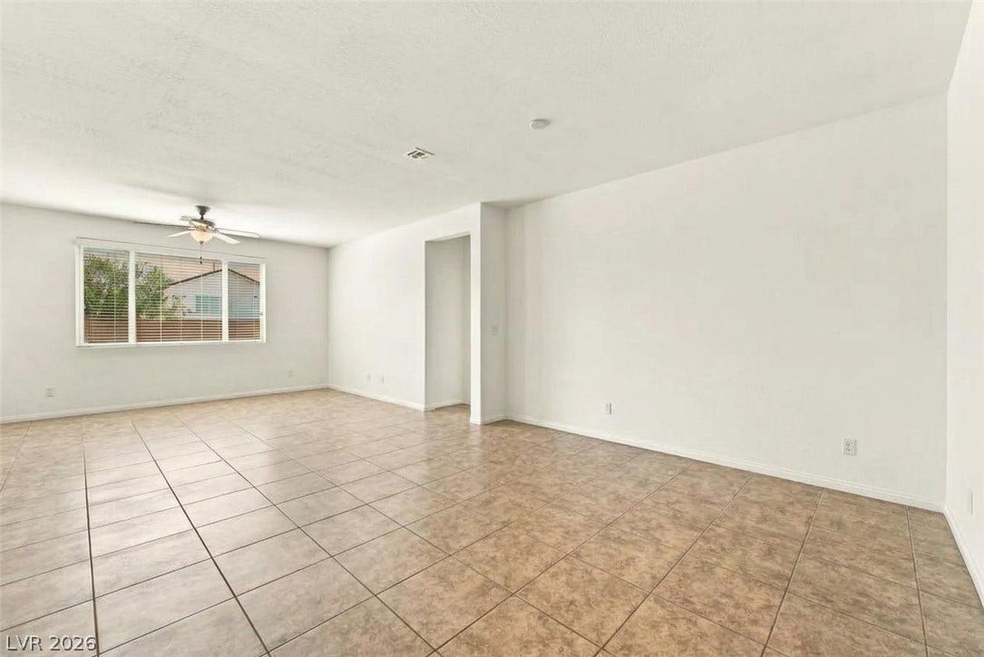 4209 Fairywren Drive, North Las Vegas, NV 89031 An open living space features durable tile flooring and a wide window overlooking the neighborhood.