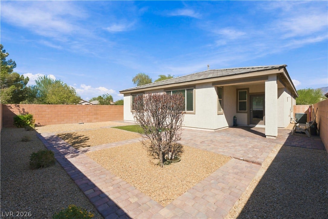 4209 Fairywren Drive, North Las Vegas, NV 89031 A spacious backyard patio and low-maintenance landscaping offer a serene outdoor escape.