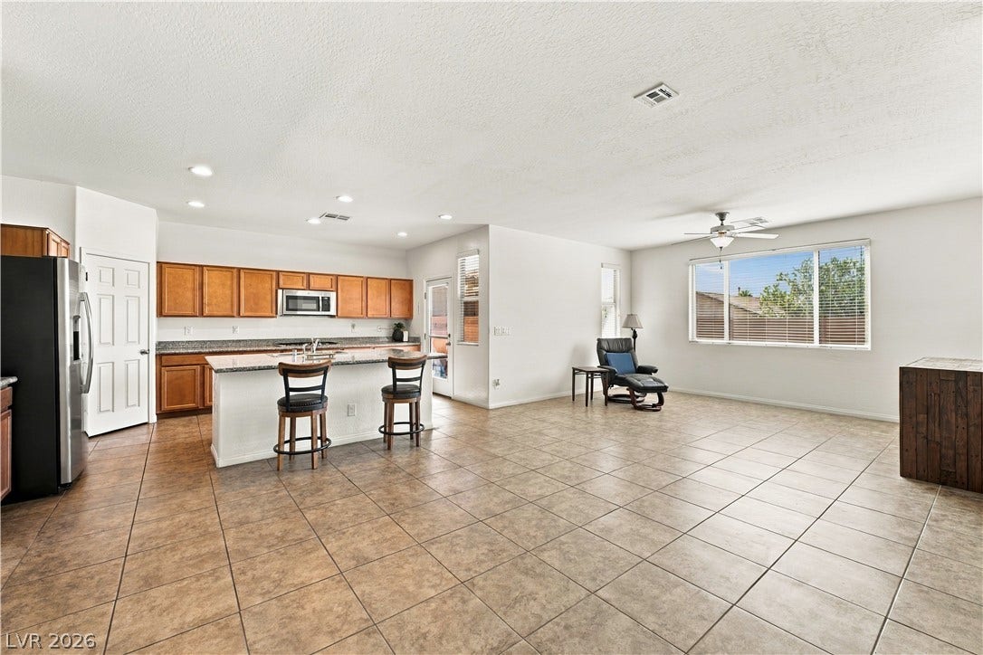 4209 Fairywren Drive, North Las Vegas, NV 89031 An open layout connects the kitchen and casual living areas over durable tile flooring.