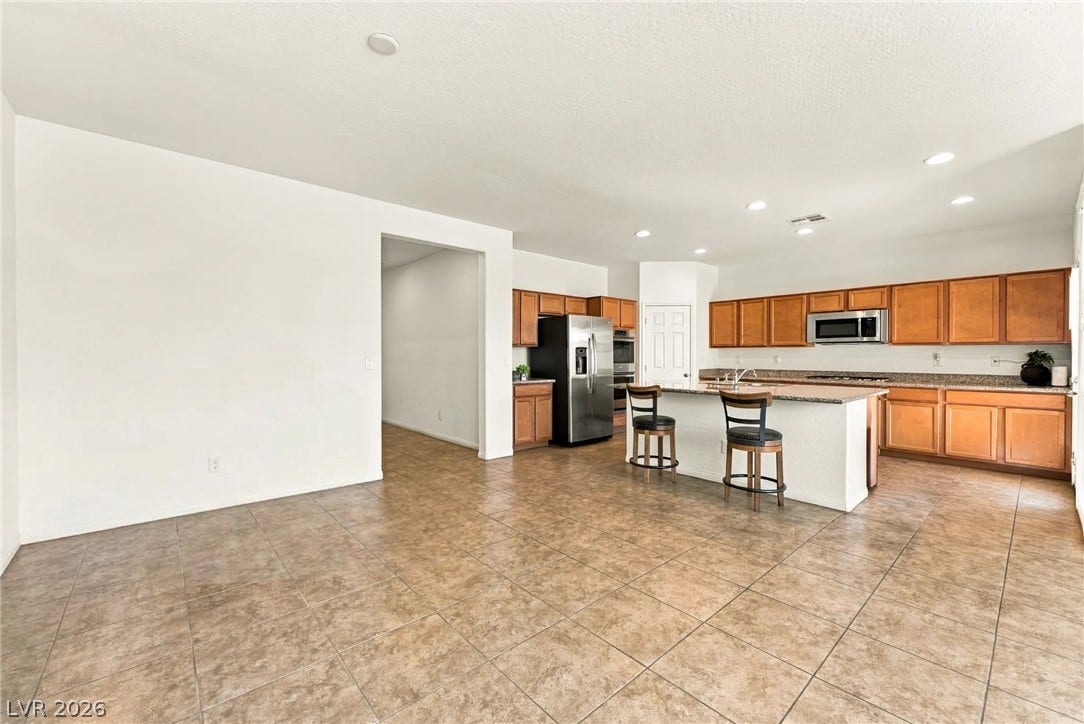 4209 Fairywren Drive, North Las Vegas, NV 89031 An open floorplan seamlessly connects the spacious dining area to the tiled kitchen.