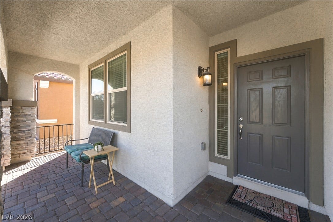 4209 Fairywren Drive, North Las Vegas, NV 89031 An inviting front entry features textured stucco walls and classic paver flooring.