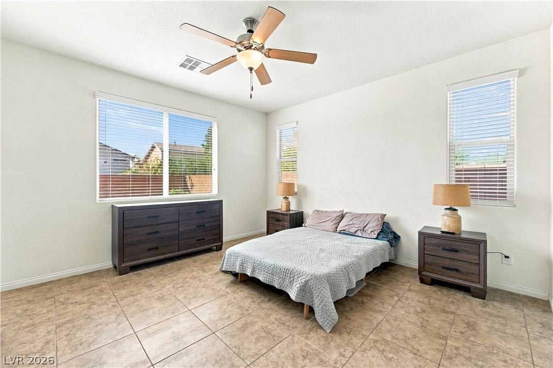 4209 Fairywren Drive, North Las Vegas, NV 89031 Tiled flooring and abundant natural light define this comfortable bedroom space.