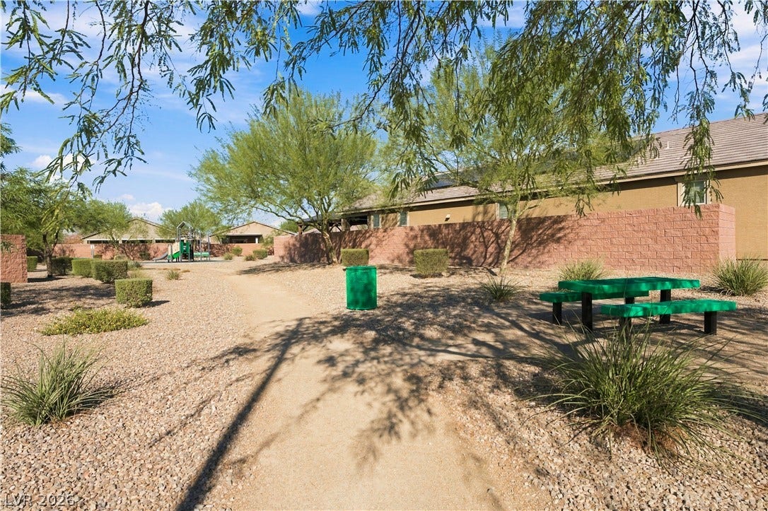 4209 Fairywren Drive, North Las Vegas, NV 89031 A winding gravel path leads through the landscaped common grounds toward a neighborhood park.