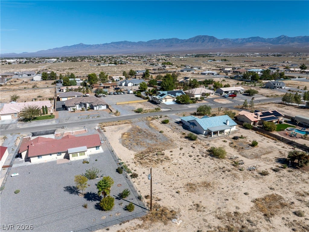 641 E Jaybird Street, Pahrump, NV 89048 Majestic mountain ridges frame this expansive desert neighborhood under clear blue skies.