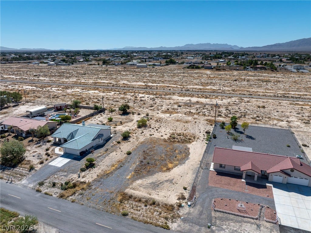 641 E Jaybird Street, Pahrump, NV 89048 Expansive desert vistas stretch toward the distant mountains under a clear blue sky.