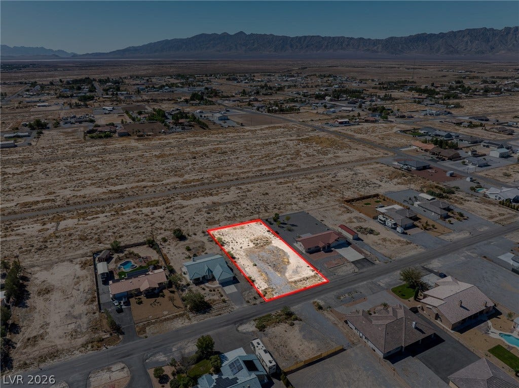 641 E Jaybird Street, Pahrump, NV 89048 Dramatic mountain backdrops frame this generous residential parcel nestled within an established neighborhood.