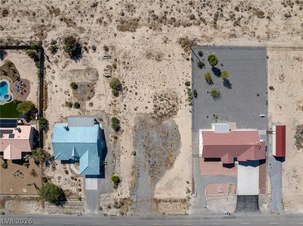 641 E Jaybird Street, Pahrump, NV 89048 Aerial perspective reveals the expansive desert lot nestled between established residential properties.