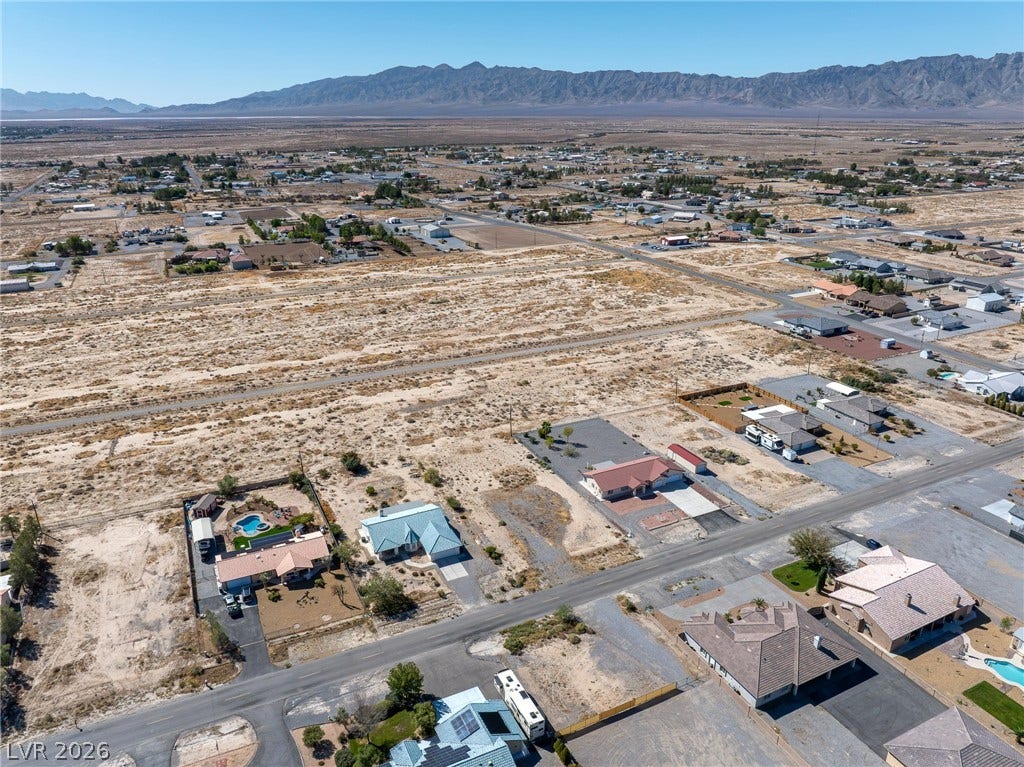 641 E Jaybird Street, Pahrump, NV 89048 A sweeping desert neighborhood view sits framed by a dramatic mountain range backdrop.