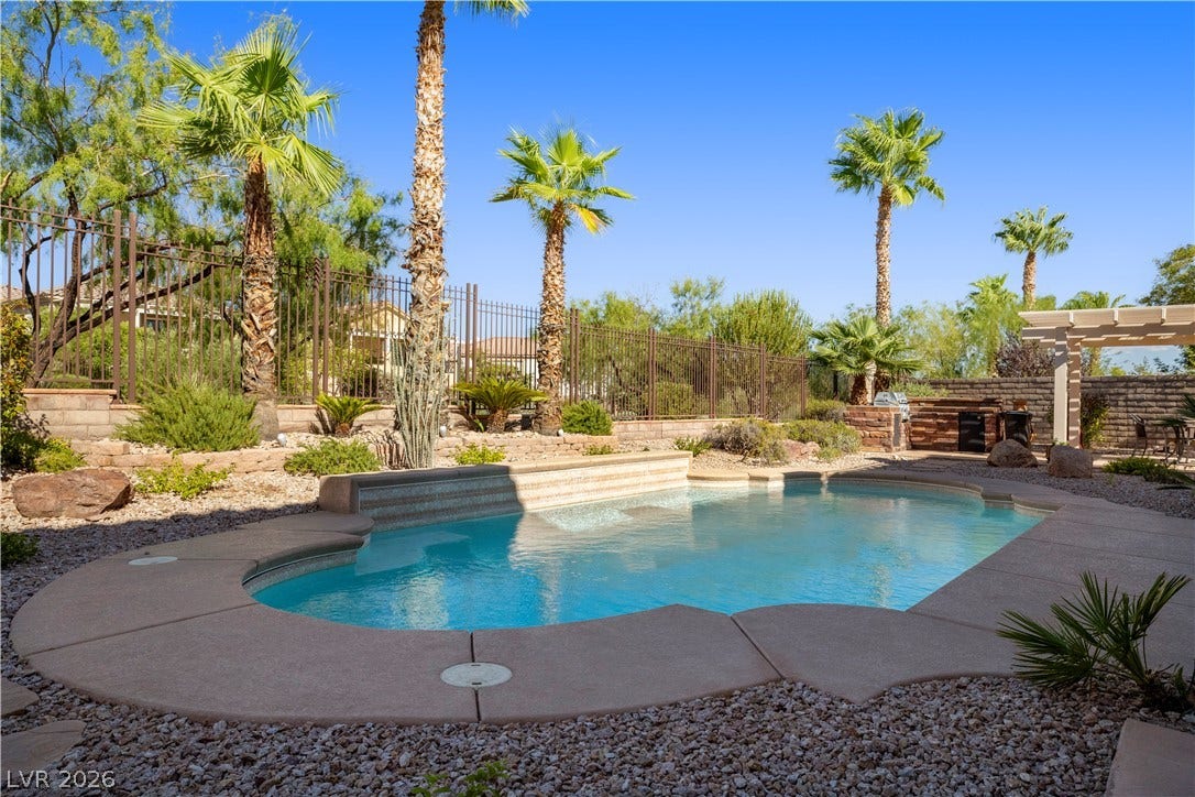 926 Loma Bonita Place, Las Vegas, NV 89138 Palm trees surround a private in-ground swimming pool framed by a textured concrete deck.