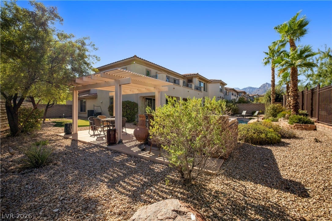 926 Loma Bonita Place, Las Vegas, NV 89138 Low-maintenance desert landscaping surrounds a shaded patio structure in the backyard.